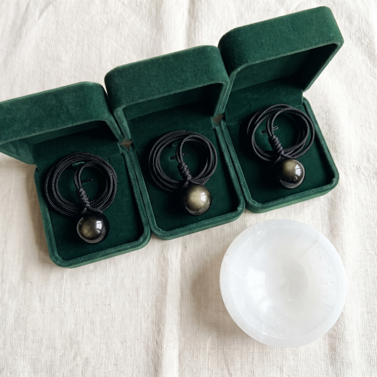 Three velvet boxes and the selenite dish