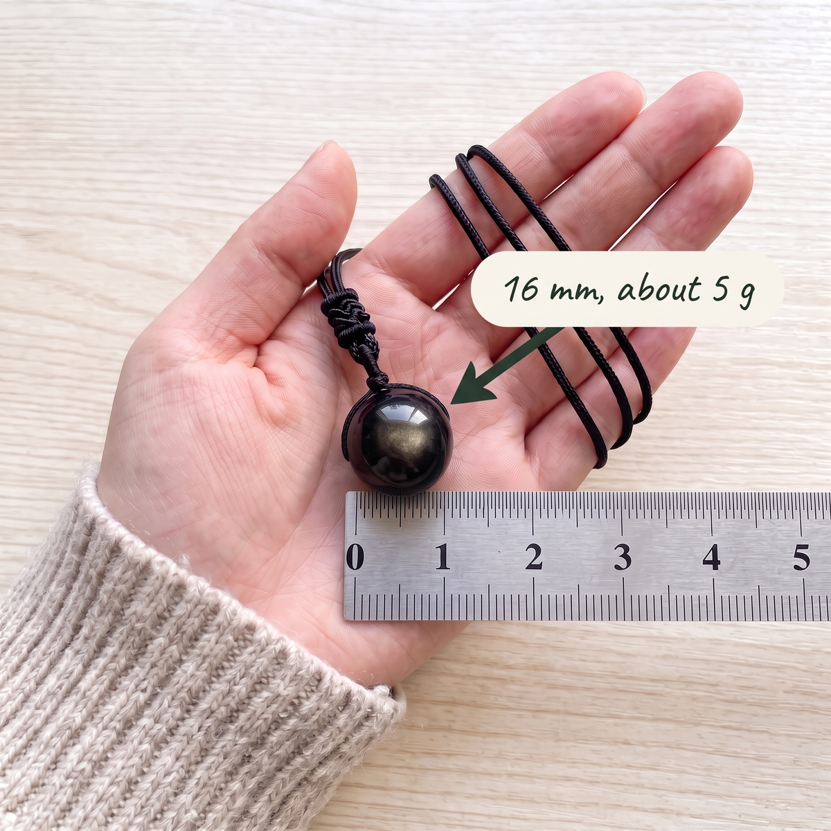 16 mm, about 5 g, in a palm beside a ruler