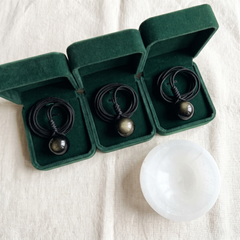 Three velvet boxes and the selenite dish